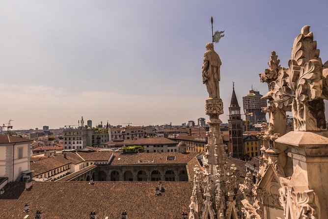 Milan Duomo Rooftop Terrace Guided Tour - The Elevator Up: First Glimpse of the Marble Giants